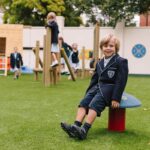 Boy Sitting On Mushroom Seat In Play Ground