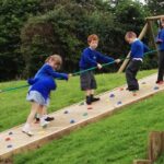 Children Playing On Rock Ramp Climber