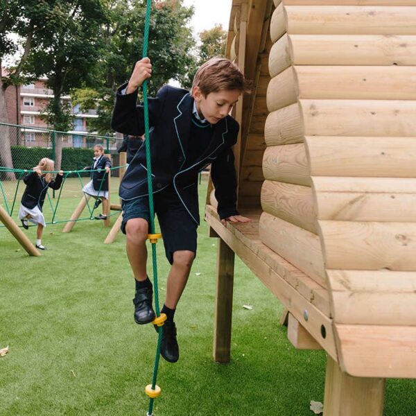 Boy Playing On Jungle Play Den In Play Ground