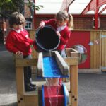 Children Pouring water onto the Niagara Water Tray