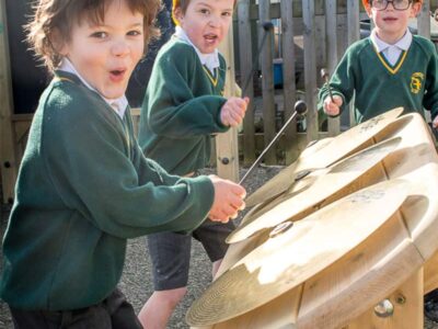 Children hitting the cymbals with sticks