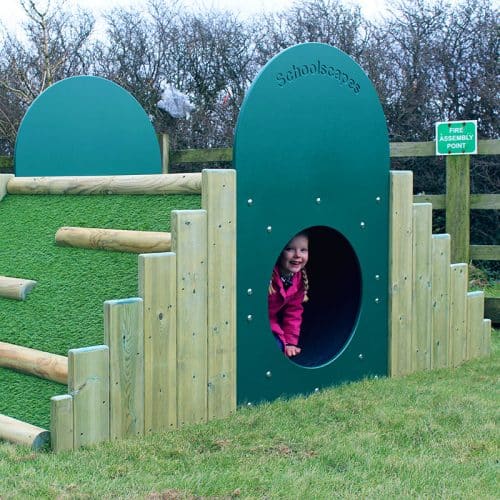 Girl Playing On Dino Mound and Tunnel