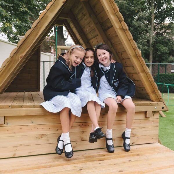 Girls Smiling On Jungle Play Den In Play Ground