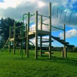 Back of treetops five playground equipment in playground