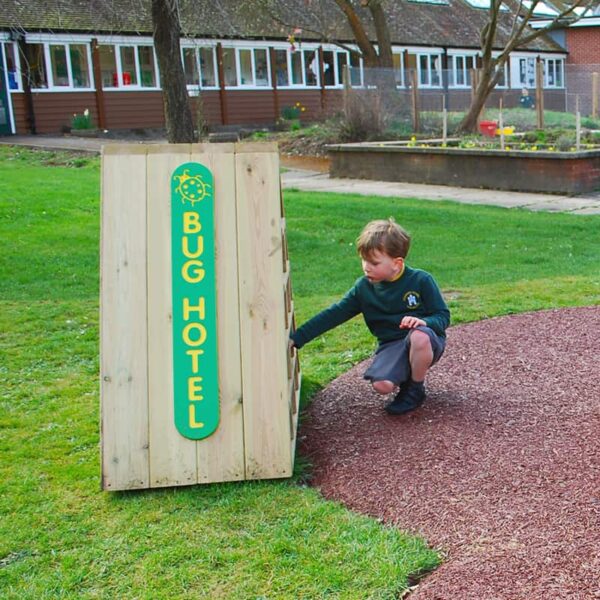Child Kneeling infront of the bug hotel