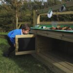 Boy Playing In Mud Kitchen Draws
