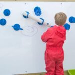 Child playing infront of a water wall from schoolscapes