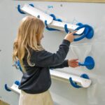 Child pouring water into a funnel on the water wall