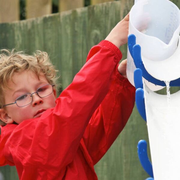 Child pouring water onto the water wall