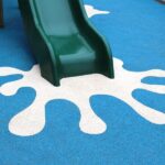 Beacon slide in playground with blue safety surfacing