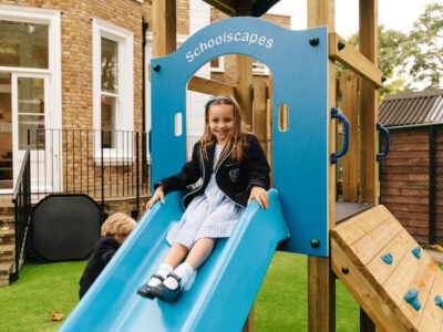 Primary school girl on blue Schoolscapes slide